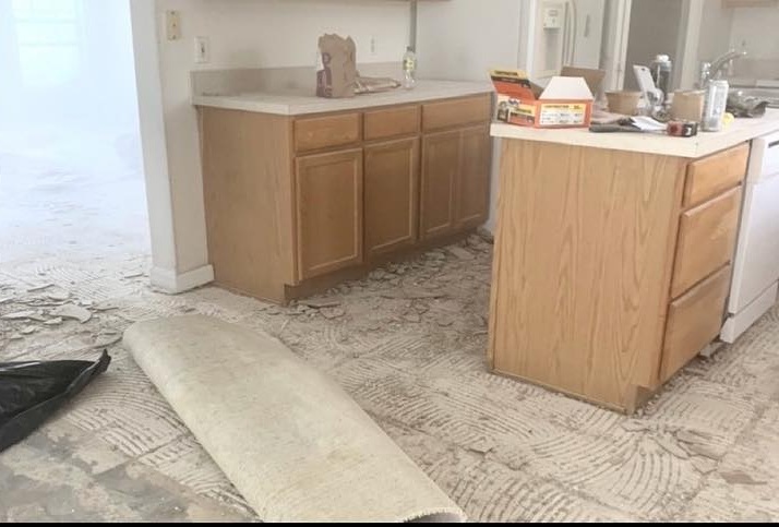 Kitchen stripped to bare subfloor before the remodel