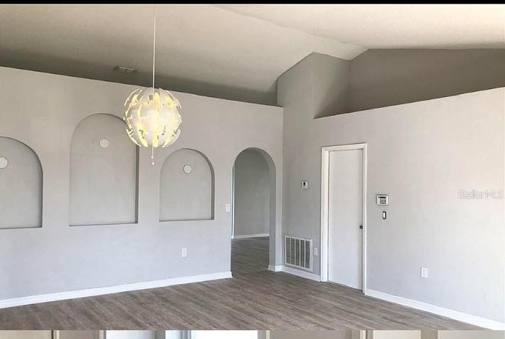 Living room with flooring carried through from the kitchen